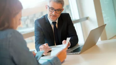 Hombre de negocios hablando con cliente en oficina.