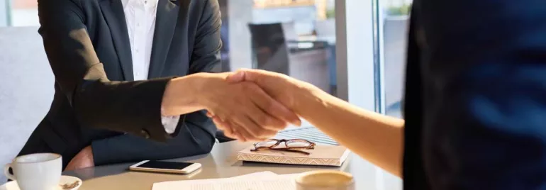 Personas estrechando manos en una reunión de negocios.