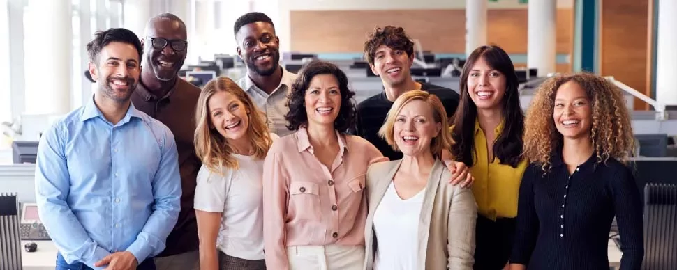 Grupo de personas sonrientes en una oficina.
